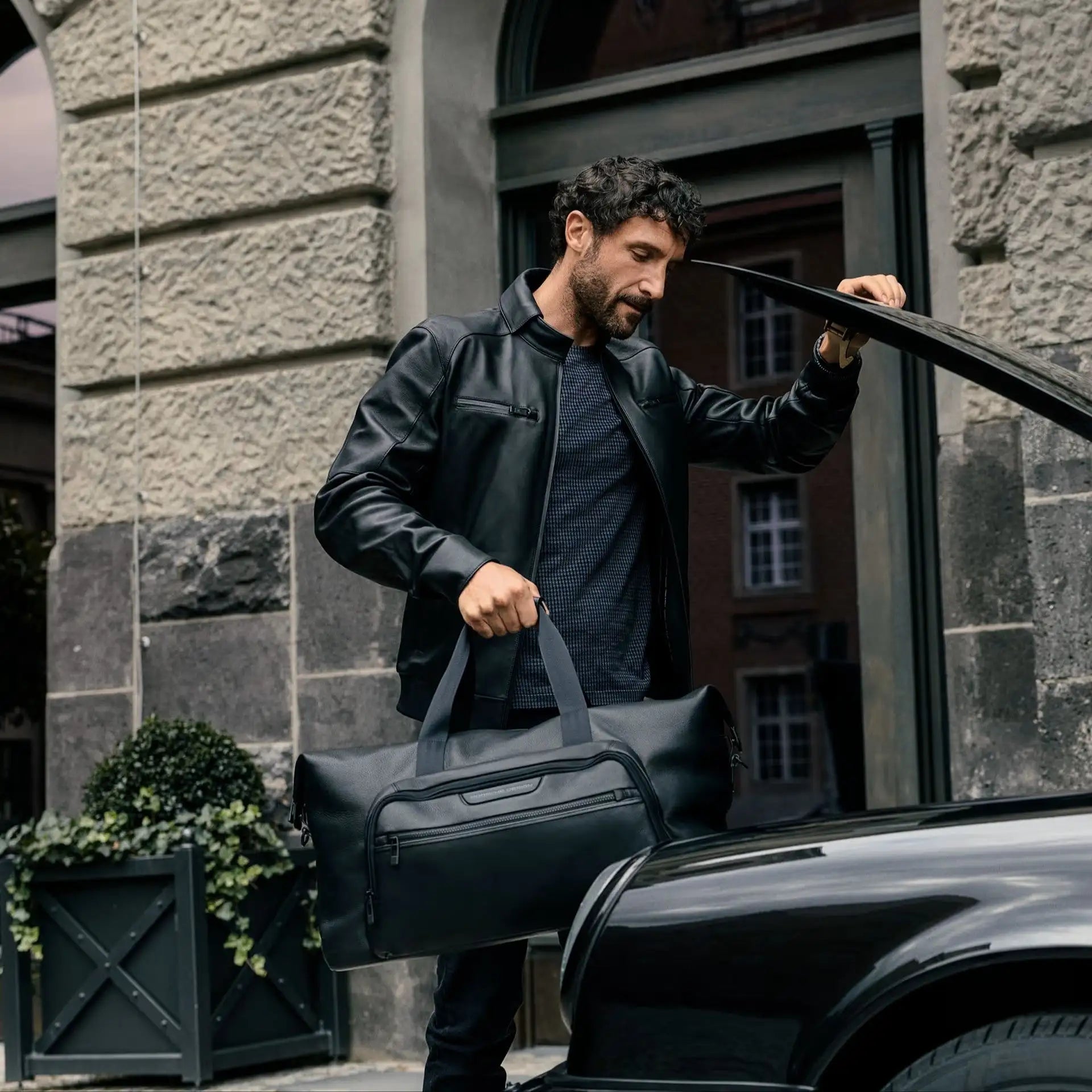 Borsa da viaggio in pelle nera con manici superiori e molteplici cerniere